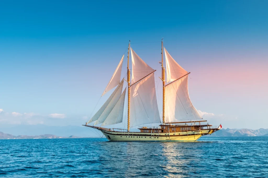 Luxury yacht sailing in Komodo National Park at sunset